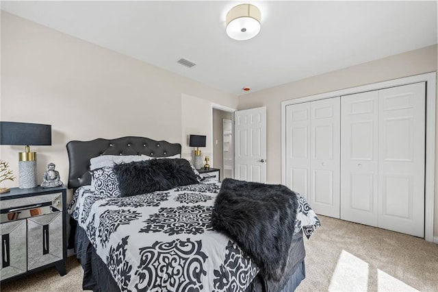 bedroom featuring light carpet and a closet