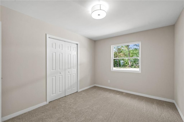 unfurnished bedroom featuring a closet and carpet floors