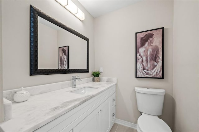 bathroom featuring vanity, tile patterned floors, and toilet