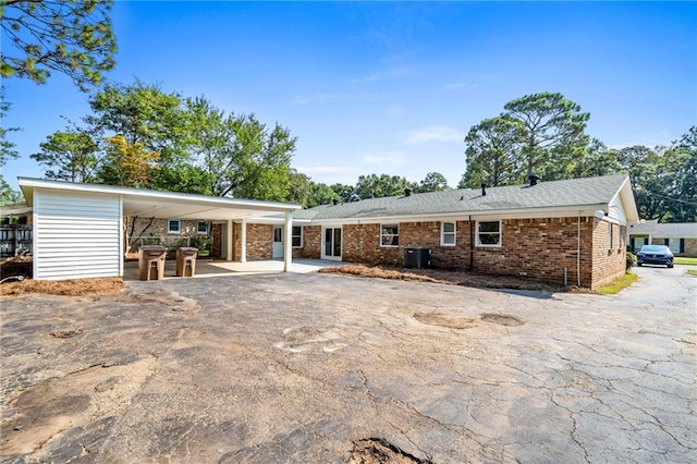 rear view of house featuring a patio and central AC unit