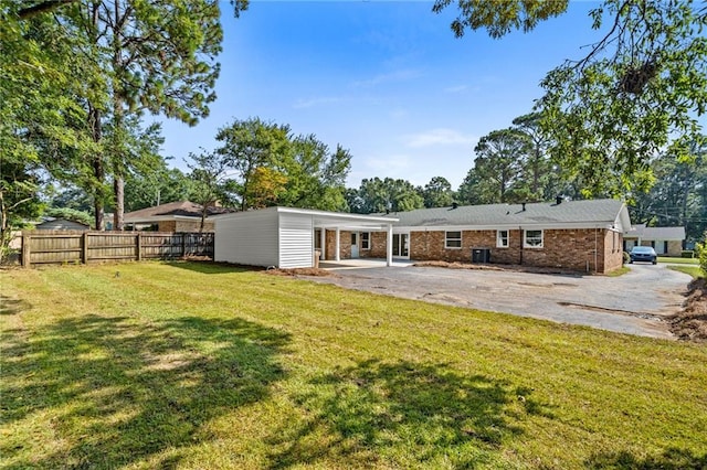 rear view of house featuring a lawn