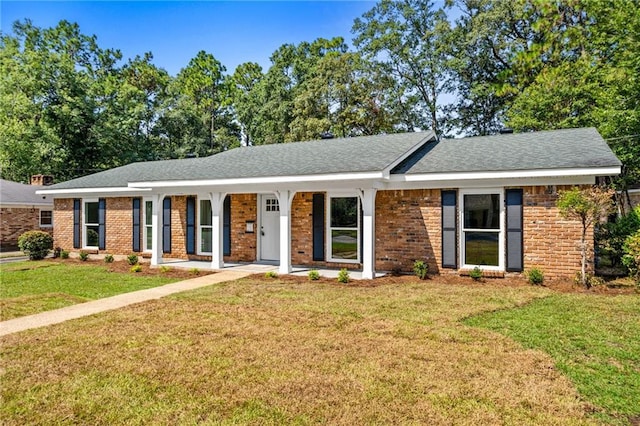 ranch-style house with a porch and a front yard