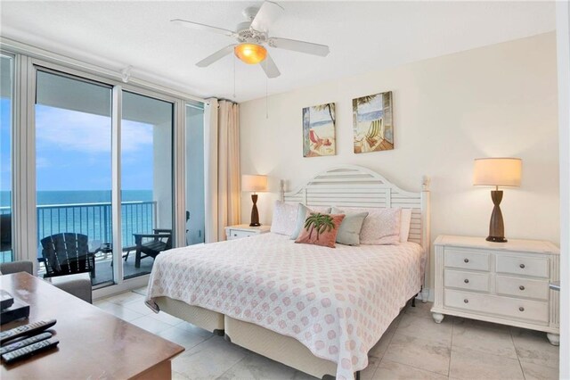 bedroom with access to outside, a wall of windows, multiple windows, a water view, and light tile patterned flooring