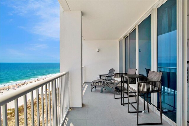 balcony with view of water and beach