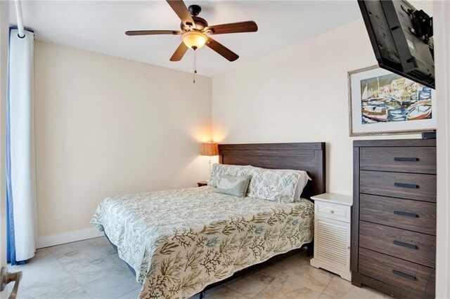 bedroom with baseboards and a ceiling fan