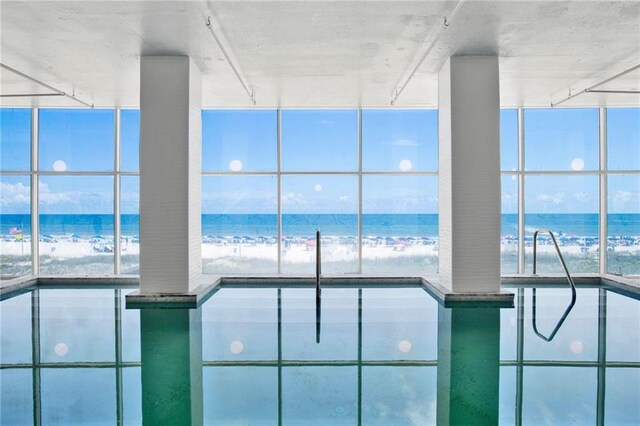 indoor pool featuring view of water and beach