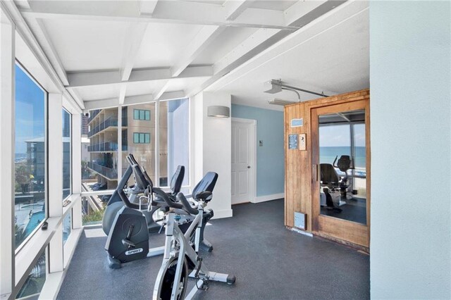 gym featuring beamed ceiling