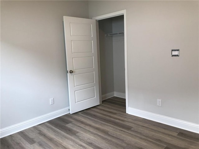 7323 Hawkins Mnr N, Mobile, AL 36695 - unfurnished bedroom featuring dark wood-style floors, baseboards, and a closet