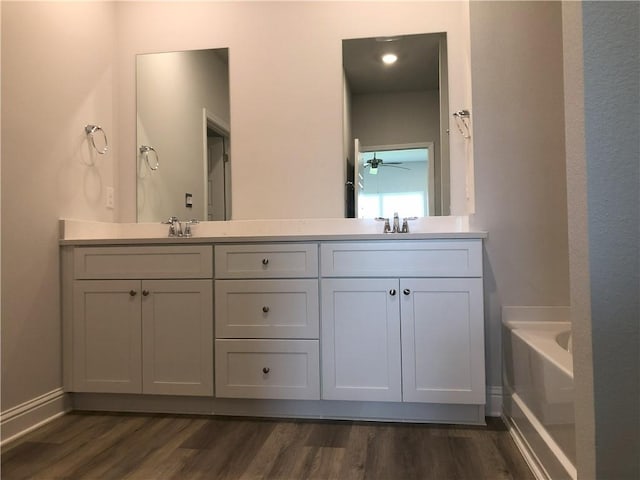 7323 Hawkins Mnr N, Mobile, AL 36695 - full bath with double vanity, wood finished floors, a bath, and ceiling fan