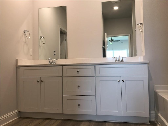 7323 Hawkins Mnr N, Mobile, AL 36695 - full bath with double vanity, wood finished floors, and a ceiling fan