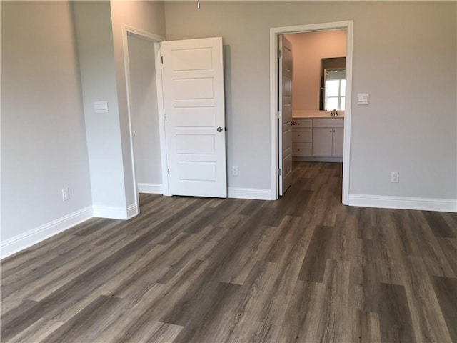 7323 Hawkins Mnr N, Mobile, AL 36695 - unfurnished bedroom featuring dark wood-style flooring, baseboards, a sink, and connected bathroom