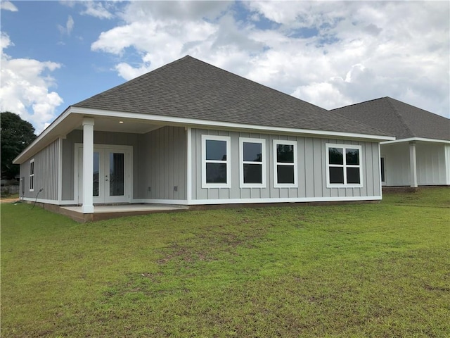 7323 Hawkins Mnr N, Mobile, AL 36695 - rear view of property featuring a shingled roof, french doors, board and batten siding, and a yard