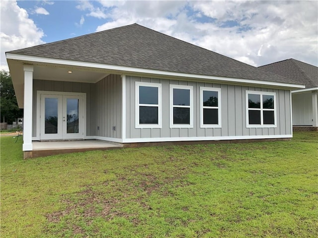 7323 Hawkins Mnr N, Mobile, AL 36695 - back of house with a shingled roof, board and batten siding, french doors, and a yard