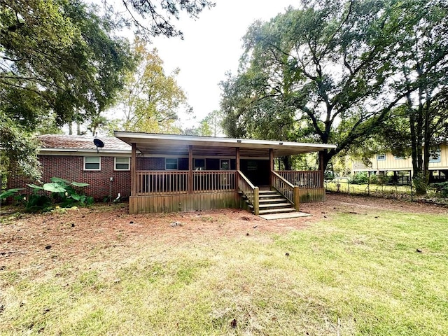 view of front of property with a front yard and a deck