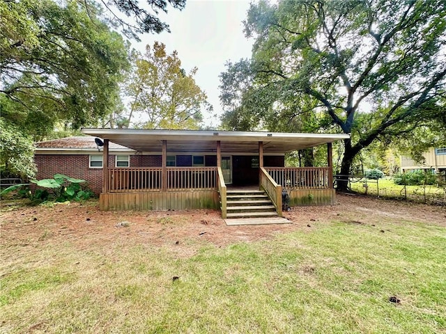 view of front of home featuring a front lawn and a wooden deck