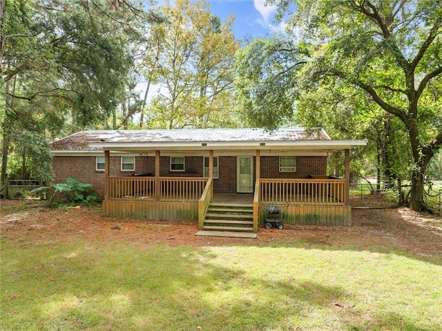 ranch-style house with a front yard and a wooden deck