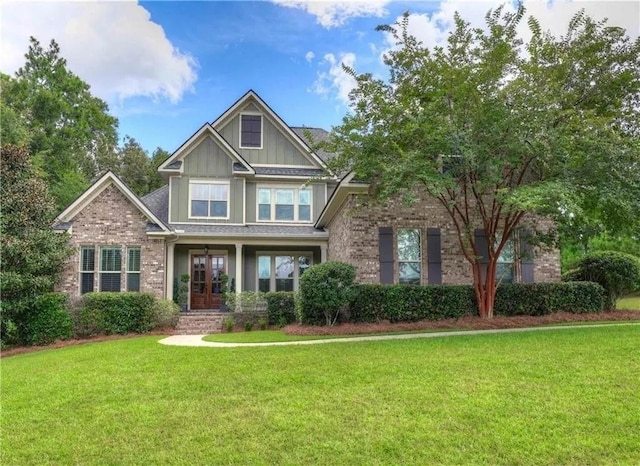 craftsman-style home featuring brick siding, board and batten siding, and a front yard