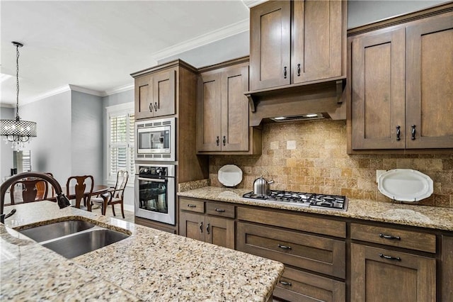 kitchen featuring custom exhaust hood, light stone countertops, appliances with stainless steel finishes, and a sink