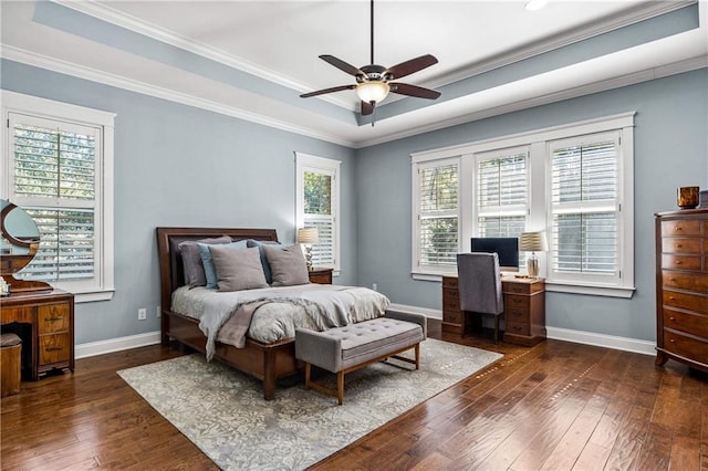 bedroom with dark wood-style floors, a tray ceiling, and baseboards