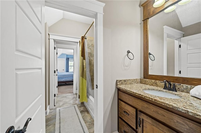 ensuite bathroom featuring vaulted ceiling, shower / tub combo with curtain, vanity, and ensuite bath