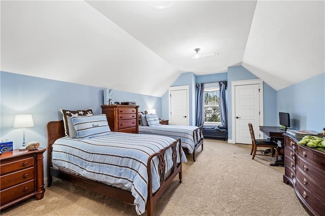 bedroom with lofted ceiling and light carpet