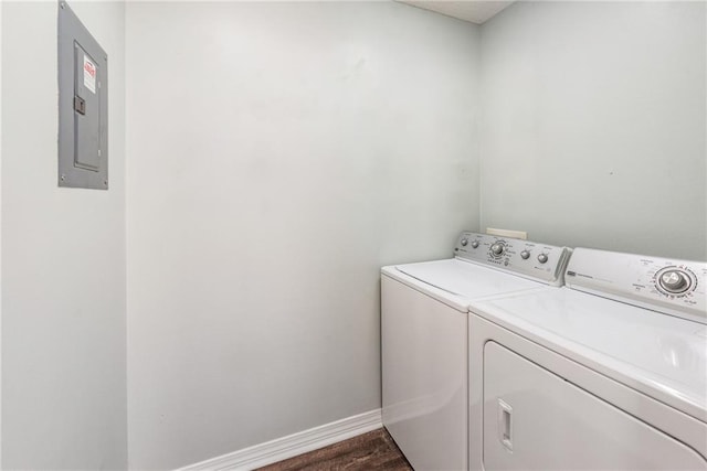 clothes washing area featuring electric panel, independent washer and dryer, and dark hardwood / wood-style floors