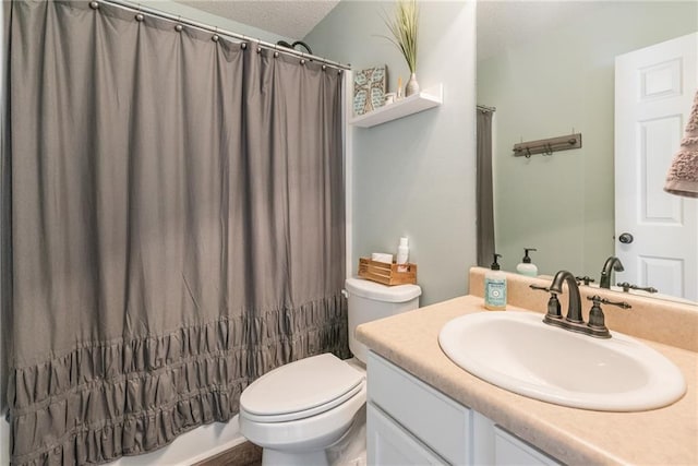 full bathroom featuring toilet, vanity, a textured ceiling, and shower / bathtub combination with curtain