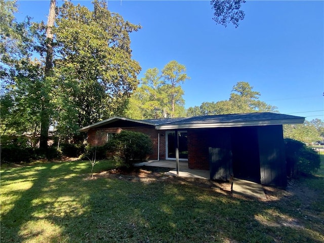 back of property featuring a patio area and a lawn