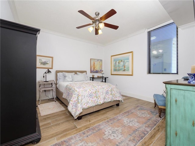 bedroom featuring ceiling fan, hardwood / wood-style flooring, and ornamental molding