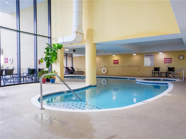 view of swimming pool featuring an indoor hot tub and a patio