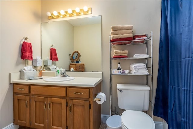 full bathroom with toilet and vanity