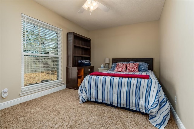 bedroom with carpet, a ceiling fan, and baseboards