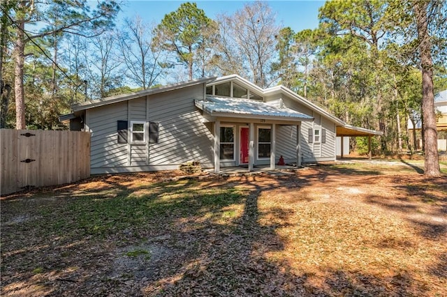 mid-century modern home with fence