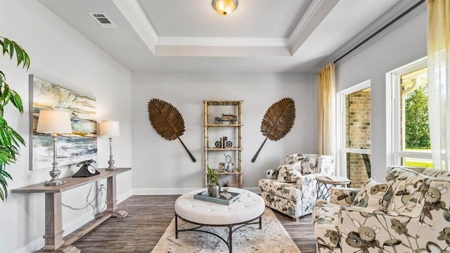 sitting room featuring a raised ceiling, crown molding, and dark hardwood / wood-style floors