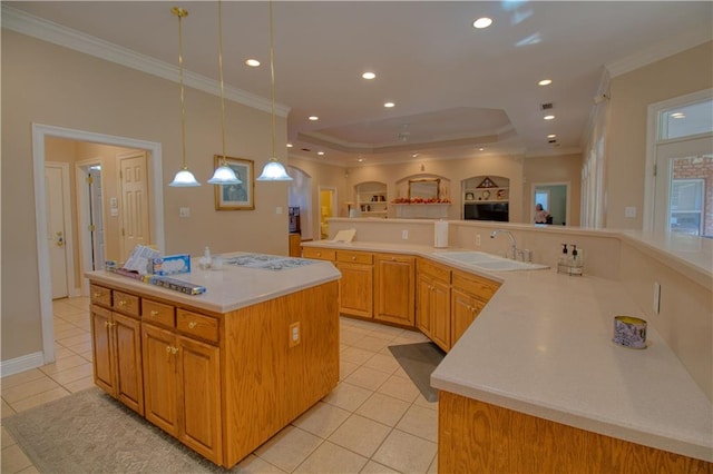 kitchen with light tile patterned floors, sink, a spacious island, and crown molding