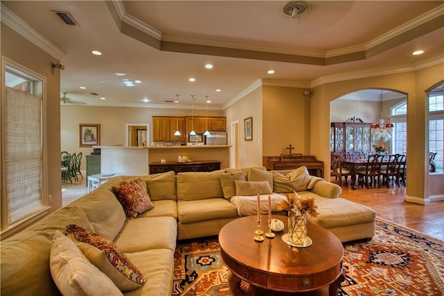 8857 Dawes Lake Rd S, Mobile, AL 36619 - living area featuring recessed lighting, crown molding, arched walkways, light wood-style flooring, and a raised ceiling