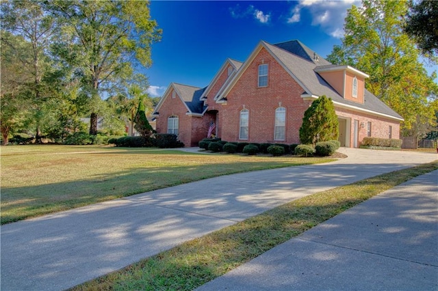 8857 Dawes Lake Rd S, Mobile, AL 36619 - view of front of home with brick siding, concrete driveway, a front yard, and a garage