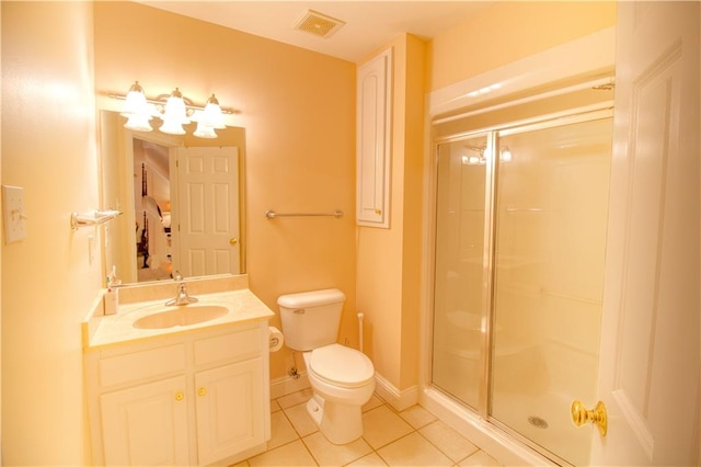 bathroom with tile patterned flooring, vanity, toilet, and a shower with shower door