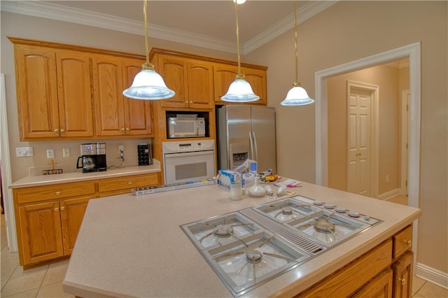 kitchen with white appliances, pendant lighting, light tile patterned flooring, and ornamental molding