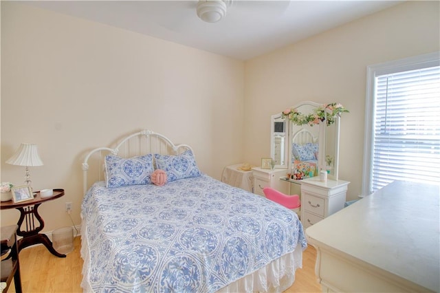 bedroom with light hardwood / wood-style flooring and ceiling fan