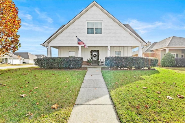 view of front facade featuring a front lawn and board and batten siding