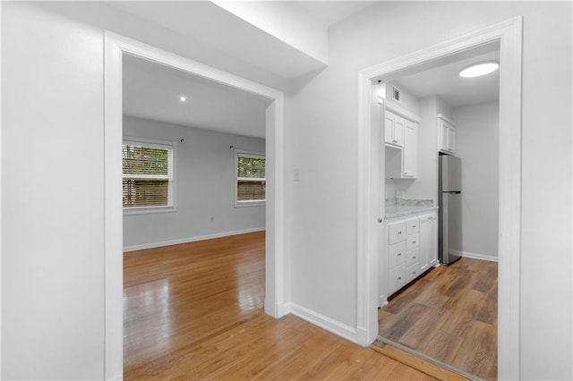 hallway with hardwood / wood-style floors