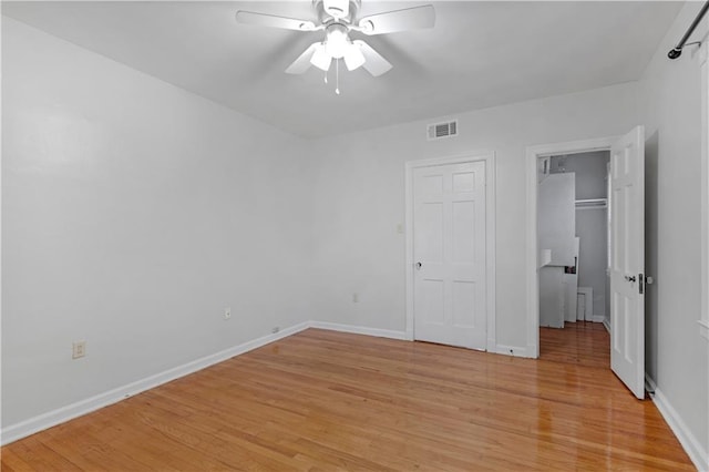 unfurnished bedroom featuring ceiling fan and light wood-type flooring