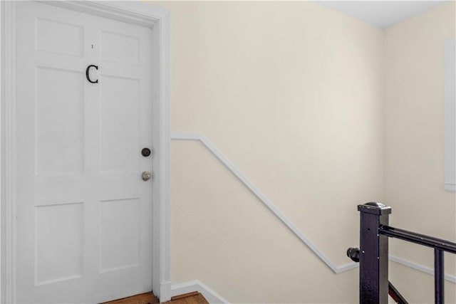 staircase with hardwood / wood-style flooring