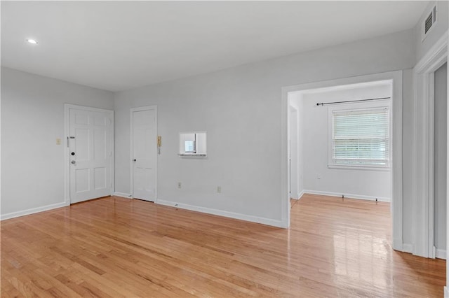 spare room with light wood-type flooring