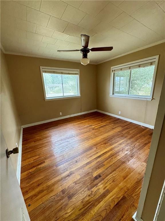 empty room featuring crown molding, ceiling fan, and hardwood / wood-style flooring