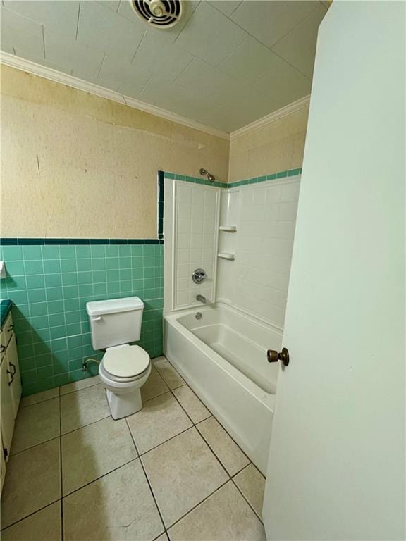 full bathroom with crown molding, tile walls, shower / washtub combination, tile patterned floors, and toilet