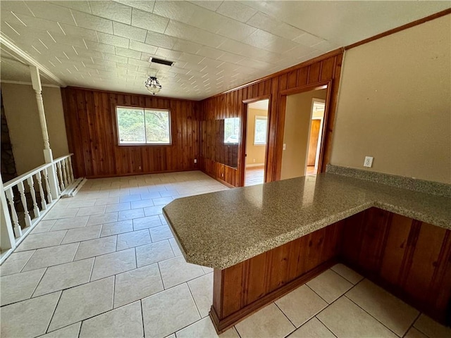 interior space featuring crown molding and wooden walls