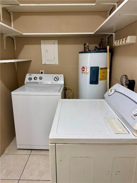 laundry room featuring electric water heater, electric panel, washing machine and dryer, and light tile patterned floors