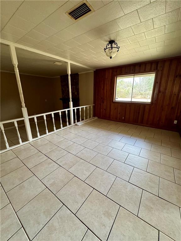 tiled spare room with wooden walls